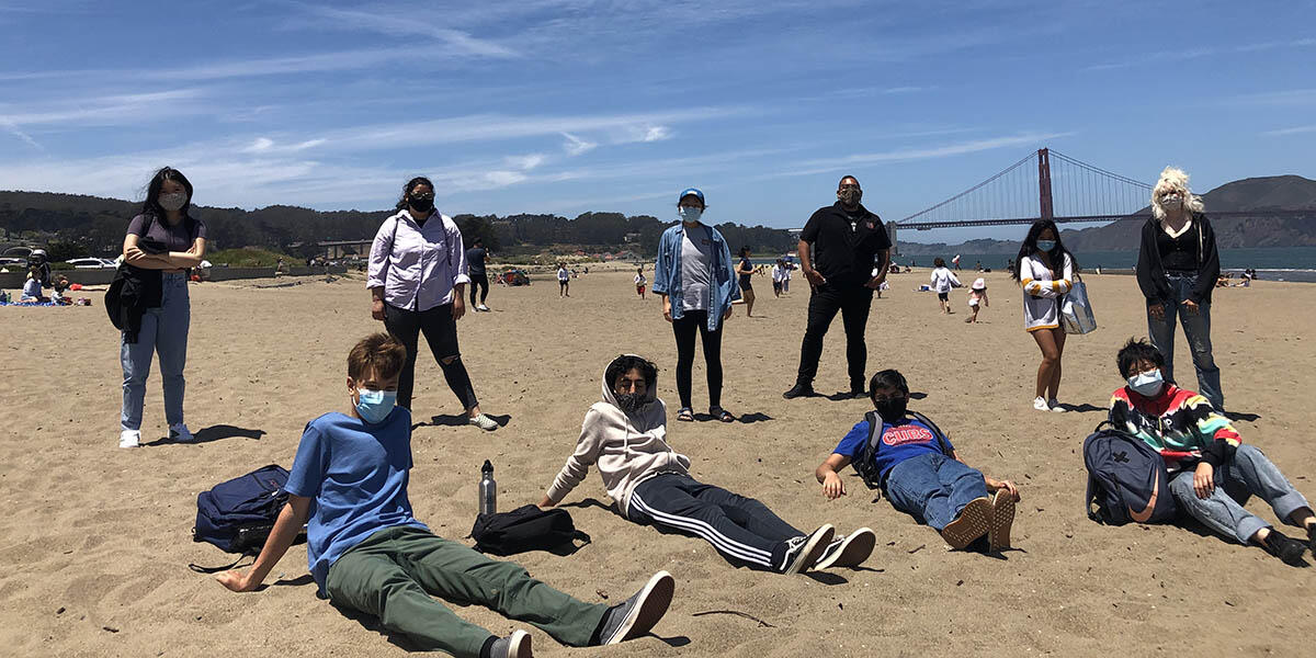 Youth who participated in the My Park Moment photo show curation on the beach near the Golden Gate Bridge.