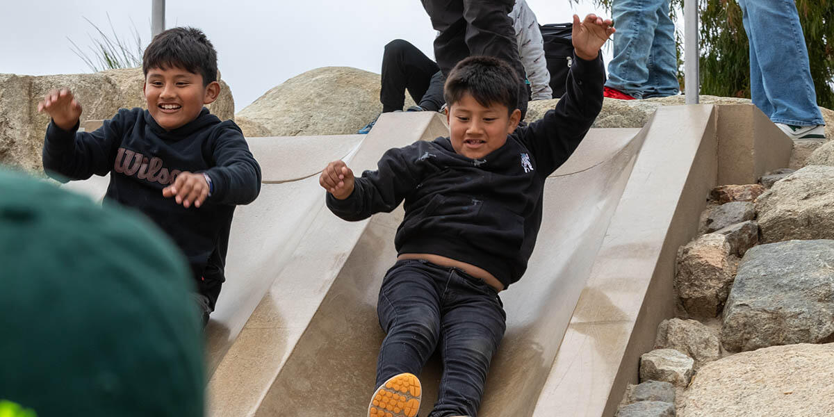 Participants from ALAS (Ayundando Latinos A Soñar) enjoying the "Raíces en la Bahía/Rooted in the Bay" event for farmworkers and their families in September 2024. Activities included crabbing, hiking, and beachside recreation.