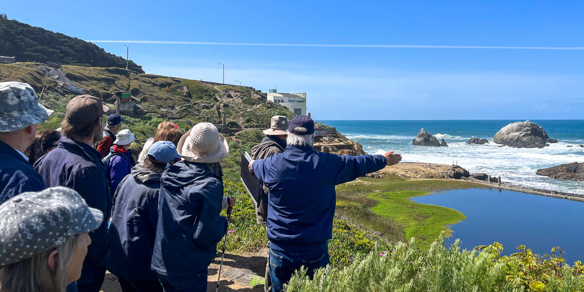 Parks Conservancy members group looks out to the ocean from Lands End