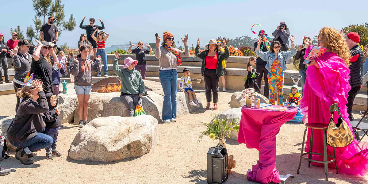 Crowd gathered around the Campfire Circle at the Presidio Tunnel Tops for Drag Story Hour.