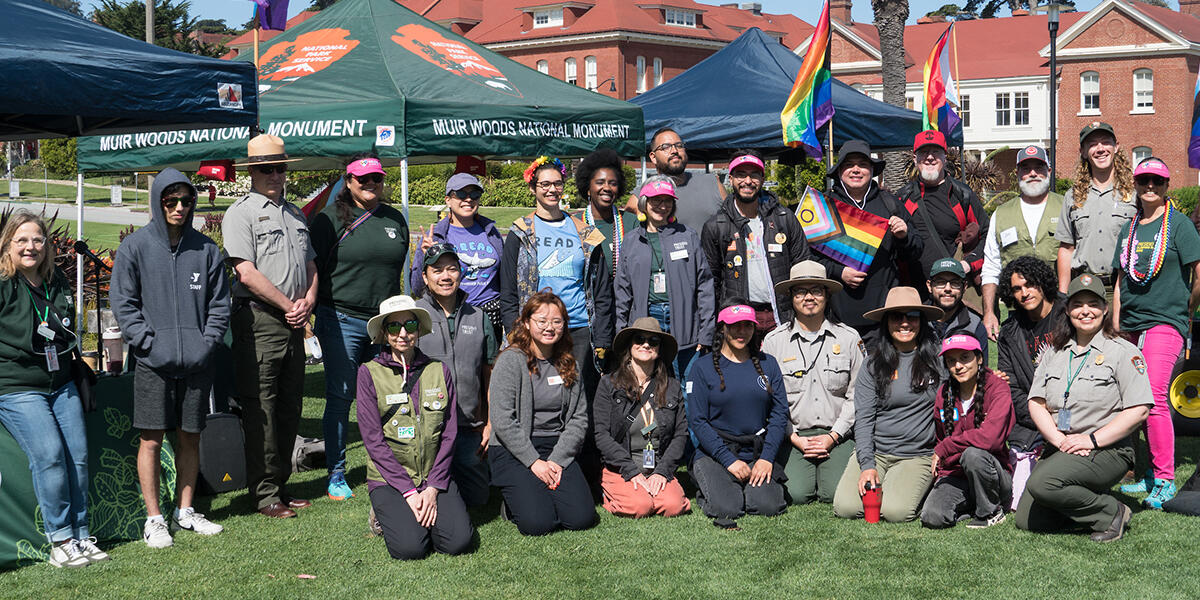 Staff from the National Park Service, Presidio Trust, and the Golden Gate National Parks Conservancy gather for a group photo at the Pride in the Presidio event.