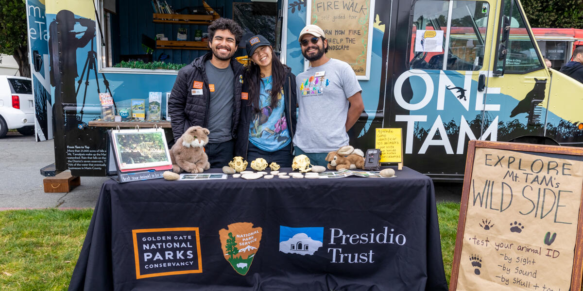 Smiling Parks Conservancy members pose for the photo in front of the One Tam Van.