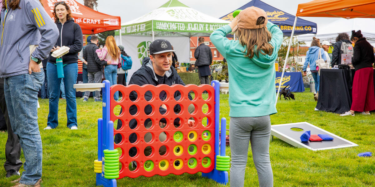 A parent and child playing lawn games at Parks4All: Brewfest in the Presidio