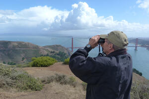 A hawkwatcher scans the eastern skies for raptors