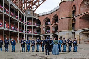 People gathered at Fort Point National Historic Site on Living History Day, dressed in civil war era union uniforms for reenactment.
