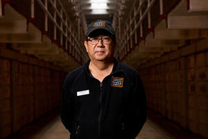 Alcatraz staff member Edwin Sera stands in front of the cell house.