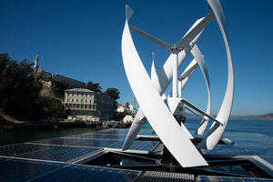 View of wind turbines and solar panels from atop an Alcatraz cruises boat.