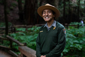 National Park Service ranger smiles in Muir Woods