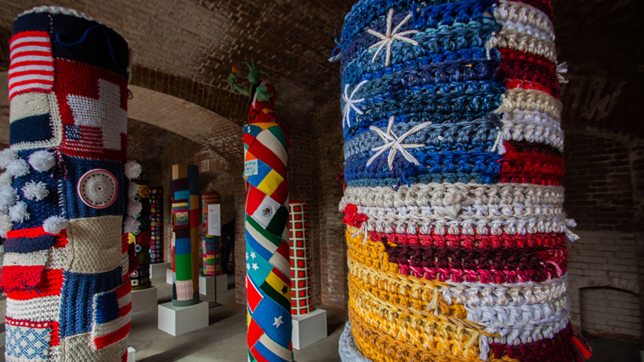 FOPO_2019_RCW_7_2x1.jpeg Pole surrounded by a knitted American flag at Fort Point National Historic Site