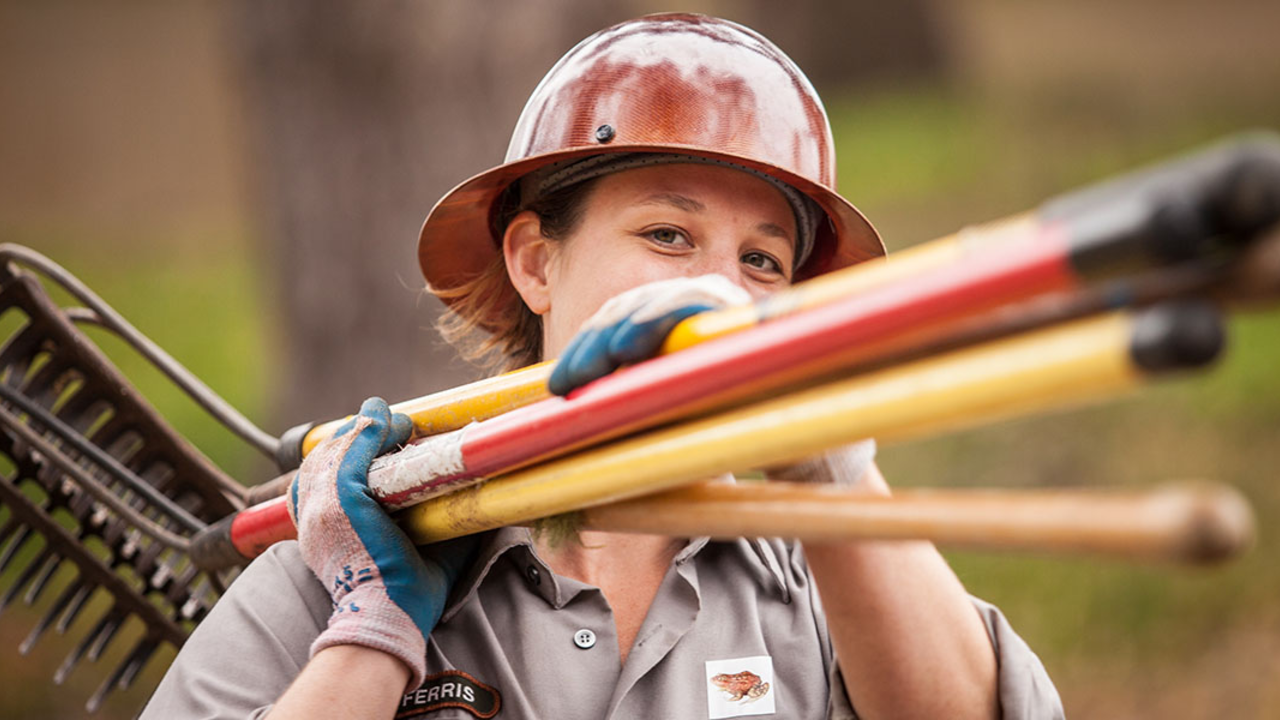 A trail builder gathers tools at National Trails Day volunteer; trails; women's trail day