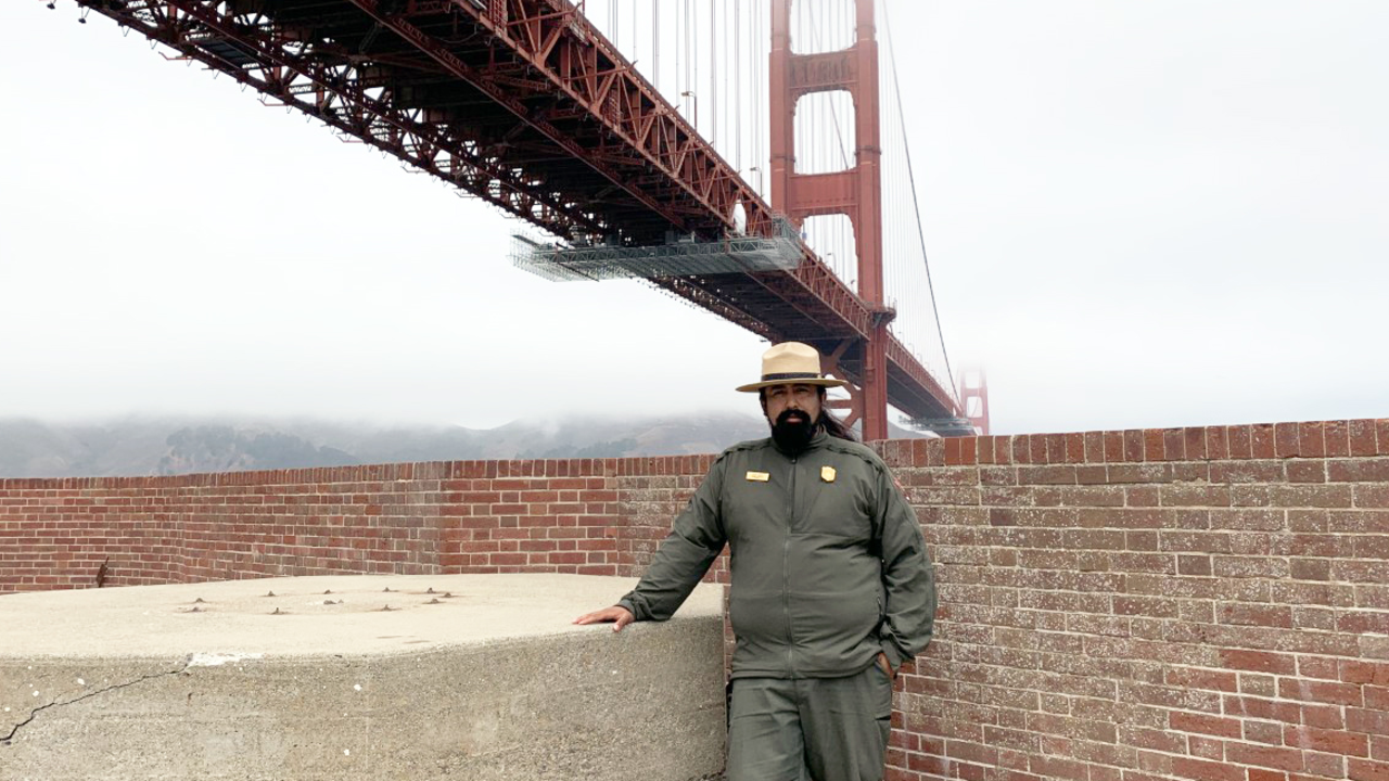 cortes_erick.jpg NPS Ranger Erick Cortes stands in front of the Golden Gate Bridge at Fort Point National Historic Site.