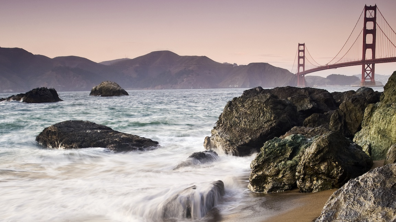 PRSF_20111020_MCu_c_4_Hero.jpg Waves crashing over rocks at Marshall's Beach with Golden Gate Bridge in the background.