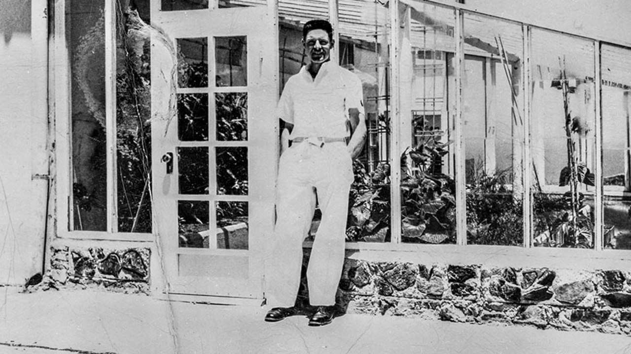 Alcatraz inmate gardener Elliot Michener in the Gardens Historic black and white photo of Alcatraz inmate gardener Elliot Michener standing by the green house