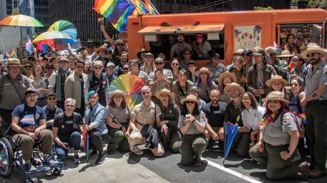 GGNRA_2023_06_25_TStarling-3_2x1.jpg Staff from the Parks Conservancy, National Park Service and the Presidio Trust pose for a group photo during the 2023 Pride Parade.
