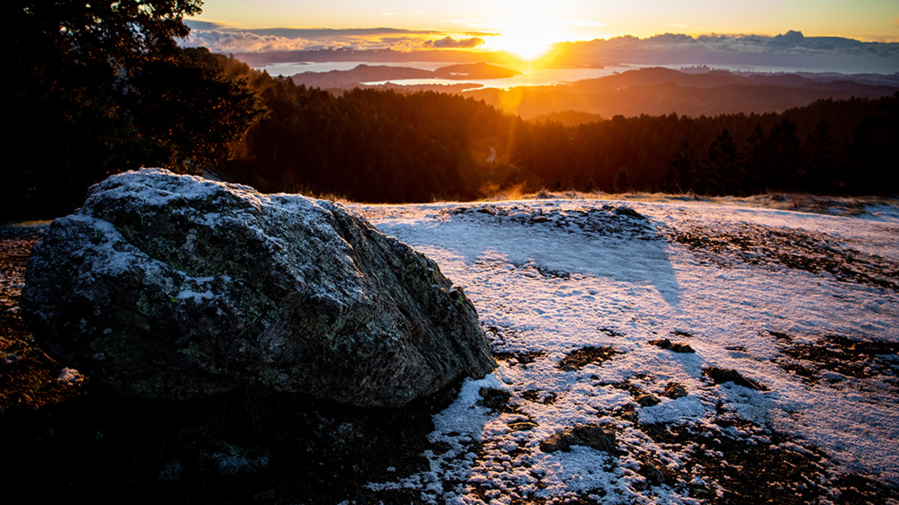 Snow at dawn on Mt. Tam. Snow on a boulder on mount tam at sunrise.