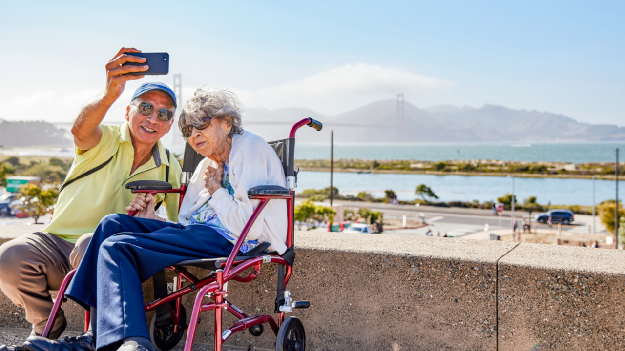 PRSF_20220717_RaS_010_2x1.jpg Elderly couple poses for a selfie before the Golden Gate Bridge at Presidio Tunnel Tops.