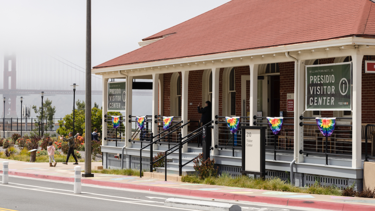 PRSF_20230604_RCW_0160_2x1.jpg Presidio Visitor Center with rainbow-colored bunting flags for LGBTQ pride.
