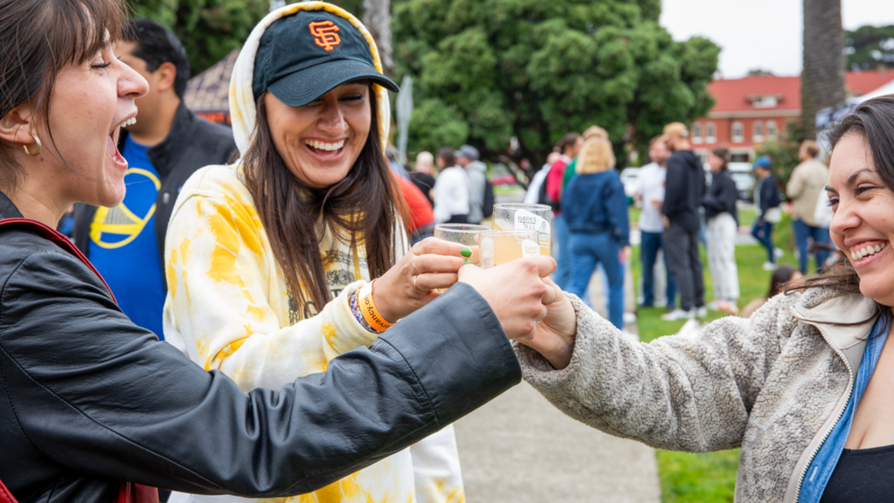 Raising a glass with friends at Parks4All: Brewfest Three smiling and laughing women raise their glasses at the Parks4All: Brewfest in the Presidio