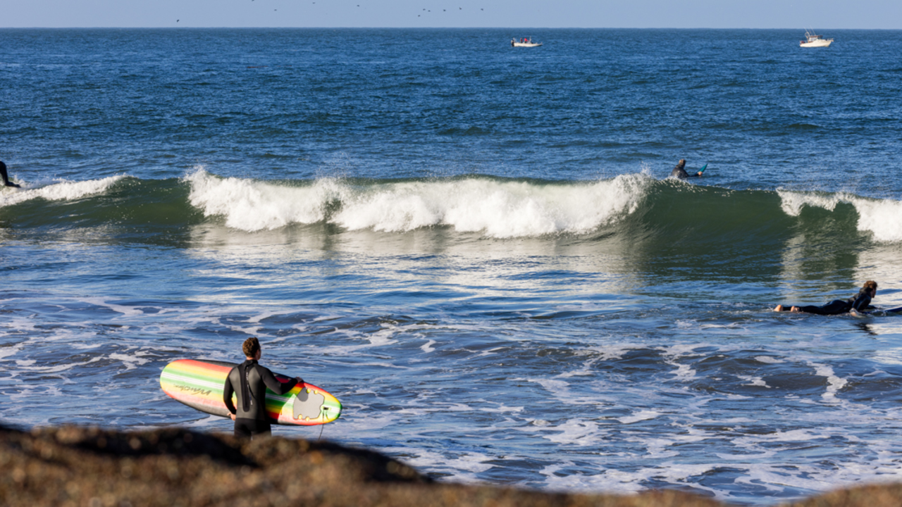 Surfing Rodeo Beach Surfers catch waves on a sunny day at Rodeo Beach in the Marin Headlands