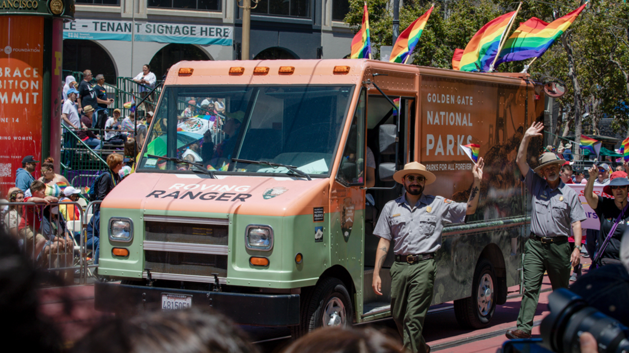 SF_20220626_RCW_0053_2x1.jpg NPS park ranger marches alongside the Roving Ranger mobile trailhead at the 2022 SF Pride parade.