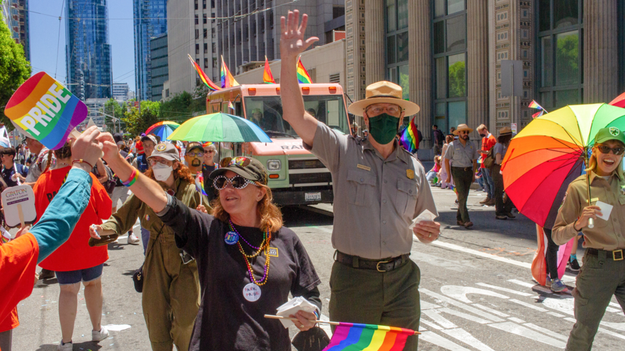 SF_20220626_RFB_268_2x1.jpg Conservancy, NPS, and Presidio Trust partners handing out stickers at the 2022 SF Pride parade.