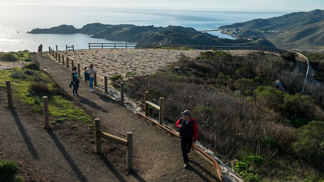 Hikers explore a newly built segment of the Hawk Hill Trail Hikers explore a newly built segment of the Hawk Hill Trail
