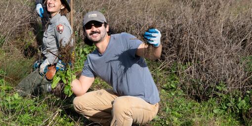 A volunteer strikes a pose while helping to restore Tennessee Valley.