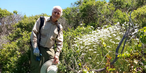 A volunteer poses with vegetation in Tennessee Valley.